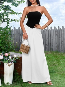 Detail of a chic black strapless bodice with white maxi skirt and slim waist design