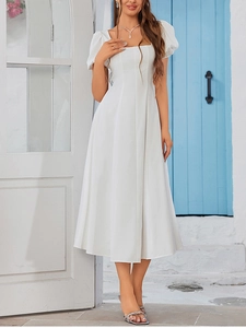 Detail of square neckline and puff sleeves on a white backless A-line midi dress