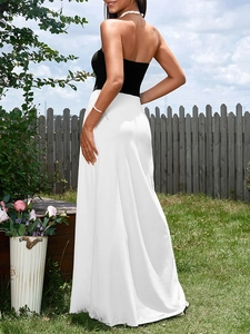 Detail of the black tube top design and elegant white draped skirt on a maxi dress