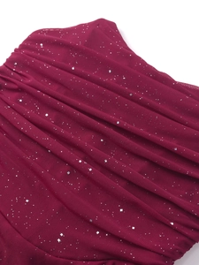 Detail of burgundy mesh dress with silver sequins and intricate pleated texture details