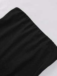 Detailed macro view of the elastic knitted fabric and pleated texture on black dress