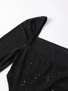 Detail of sheer black mesh dress featuring shimmering silver sequins and elegant pleats