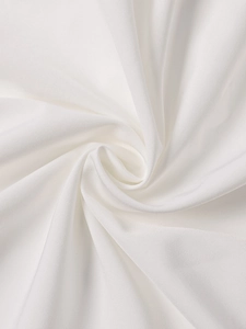 Detail shot of white lace dress fabric with elegant pleated texture and soft draped folds