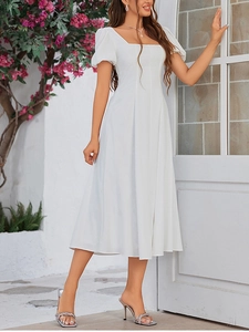 Detail of white square neck A-line midi dress with puff sleeves in sunny outdoors