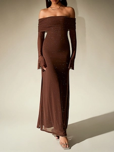 Detail of shimmering silver glitter on a dark brown off-shoulder evening dress fabric