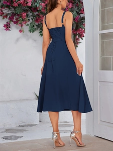 Detail view of the criss-cross back lacing on a navy blue floral midi sundress
