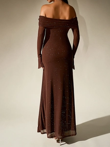 Detail of off-shoulder mesh dress in dark brown with silver glitter stars and long sleeves