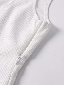 Close-up of white waffle knit fabric with invisible zipper detail on the dress side