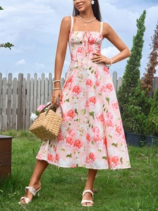 Detail of floral print maxi dress with tie-up front and feminine high-waist A-line silhouette