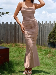 Detail of elegant beige cowl neck dress featuring side ruching and delicate straps