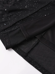 Detail of black mesh dress with silver sequins showing neat double-needle stitching