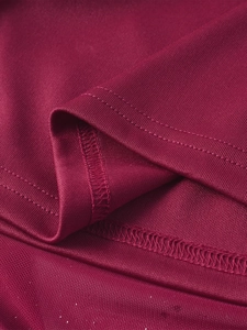 Close-up of double-needle stitching and fishbone mesh texture on wine red corset dress