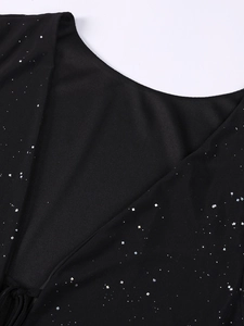 Détail du décolleté en V plongeant avec paillettes argentées sur robe en maille noire sexy