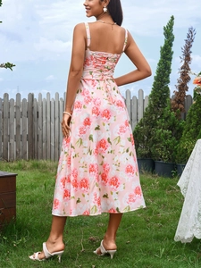 Detailed back view of floral midi dress with lace-up ties and pink rose pattern