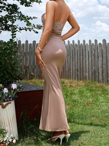 Detailed view of backless maxi dress with delicate lace patchwork and slim fit silhouette