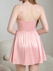 Detailed back view of pink satin mini dress with open back and adjustable straps