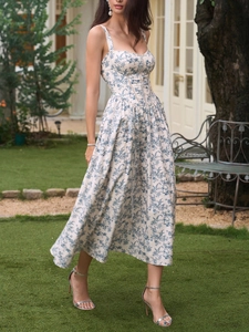 Detail of blue floral print sundress featuring structured bodice and elegant hemline