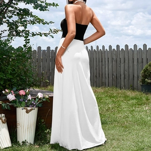 Elegant strapless black and white backless maxi dress for women in a garden setting