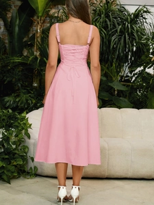 Detail of pink fishbone backless dress featuring lace-up drawstring and slit hem