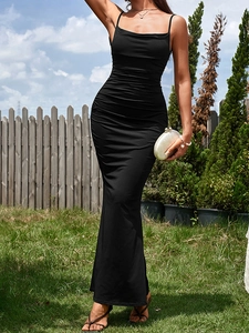 Close-up of black bodycon maxi dress featuring textured ruching and fishtail hemline
