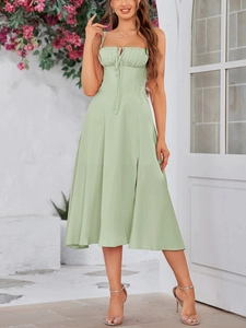 Detail of mint green bustier dress featuring front drawstring tie and side leg slit