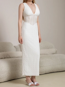 Detailed view of white sleeveless dress with intricate eyelet lace and crochet stitching