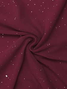 Detailed texture of burgundy mesh fabric with shimmering silver sequins and fine knit weave