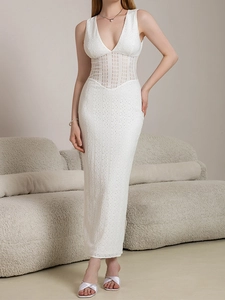 Detailed view of the intricate white lace embroidery and hollow stitching on the dress