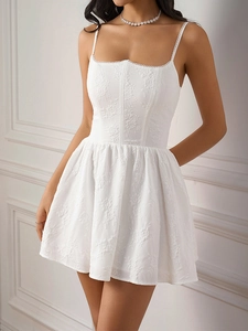 Detail of white corset dress showing 3D floral texture and elegant square neckline