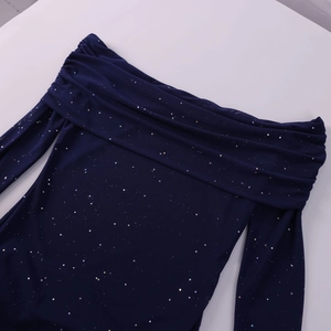 Detail of navy off-shoulder dress with sparkling sequins and elegant pleated neckline