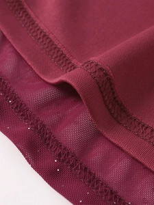 Detail of burgundy mesh dress with silver sequins and professional overlock stitching
