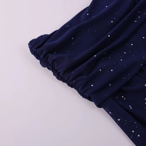 Macro detail of navy mesh sleeve featuring silver sequins and elastic pleated cuffs
