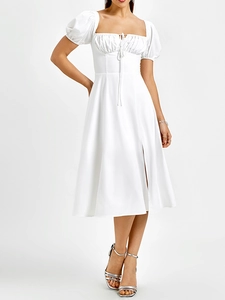 Détail de la robe blanche à épaules dénudées avec encolure carrée et laçage sur la poitrine