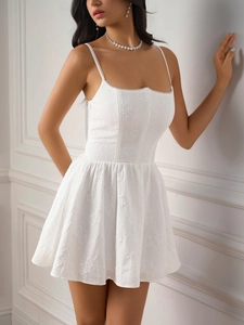 Close-up detail of white fishbone corset dress featuring elegant floral jacquard texture