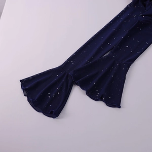 Close-up of navy blue mesh dress with silver glitter sequins and wavy hemline detail