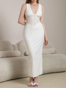 Close-up of white deep V-neck dress with intricate lace inserts and eyelet fabric details