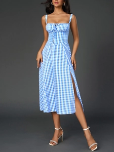 Detail of blue gingham dress featuring a lace-up bodice and corset-style waist design
