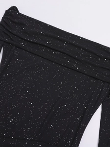Detail of off-shoulder mesh neckline with delicate ruffles and shimmering silver sequins