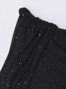 Detail of black mesh fabric featuring silver sequins and fine glitter with elastic pleats