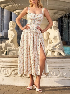 Detail of floral spaghetti strap dress featuring corset bodice and high side slit