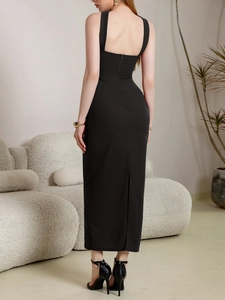 Detail of elegant black strapless dress featuring back zipper and stylish hem slit