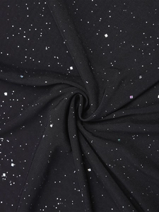 Detail of black mesh fabric featuring silver glitter and square metallic sequins texture