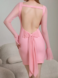Detail of pink dress featuring a backless design and a decorative large 3D bow