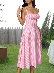 Close-up of pink gingham midi dress featuring front tie detail and slim fit corset bodice