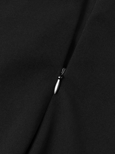 Detail of a black evening dress featuring a premium silver invisible zipper closure