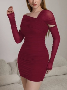 Detail of burgundy ruched mesh dress featuring side cut-out and long sleeve glove design