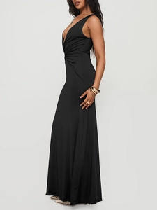 Detailed close-up of the elegant deep V-neckline and draped ruched waist on a black dress