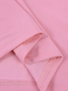 Detail of pink mesh fabric showing fine honeycomb texture and double-stitch hem