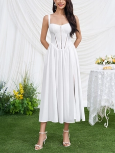 Detail view of white slip dress featuring a corset waist structure and high side slit