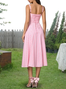 Detail of a pink and white plaid sundress featuring a lace-up tie back and open-back style